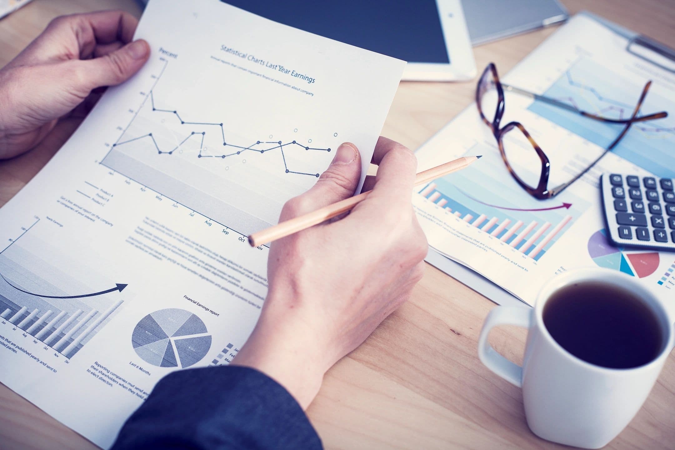 Accounting workspace with charts and coffee